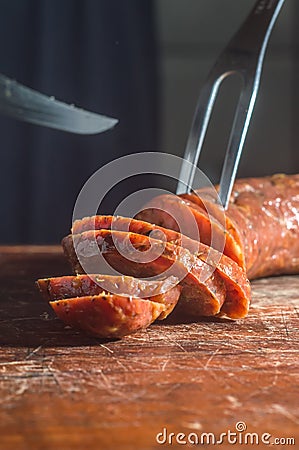 Sliced â€‹â€‹smoked calabrese sausage in a wooden table,copy space Stock Photo